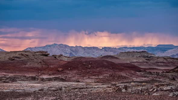 Sunset timelapse as storm moves over the desert mars like landscape in Utah alt