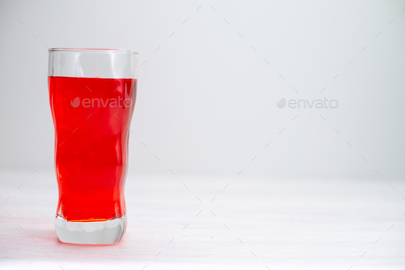front view red juice icing drink red colored inside long glass on the white desk juice fruit drink