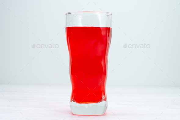 front view red juice icing drink red colored inside long glass on white desk juice fruit drink