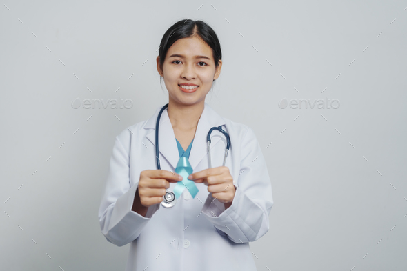 Doctor asian female specialist holding blue ribbon and stethoscope and Breast cancer awareness