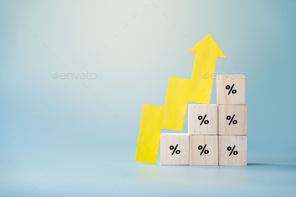 Yellow paper cut arrow going up positive trend on wooden blocks with percentages