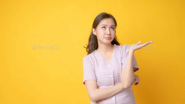 Portrait of Asian Thai woman as don\'t care and no interesting any thing with empty her left hand