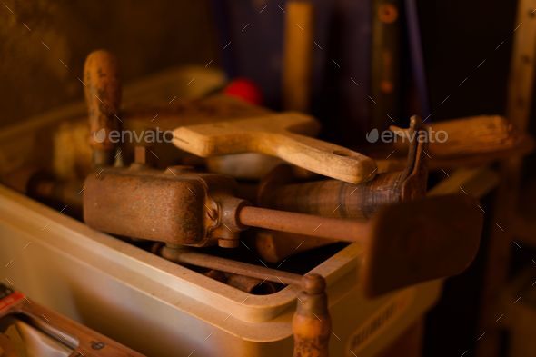 Closeup of different tools in a plastic box in a garage