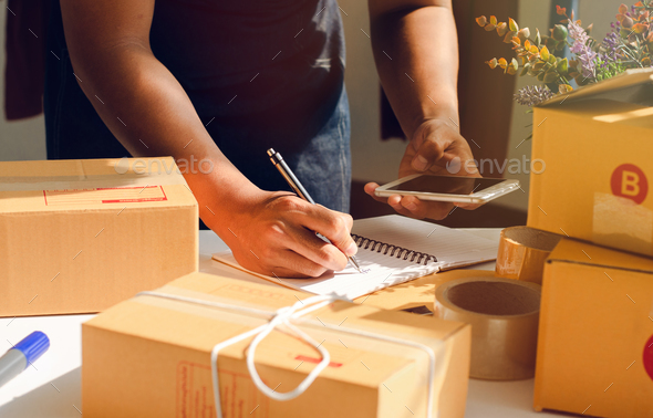 The owner of an online store is counting parcels to be sent to customers.