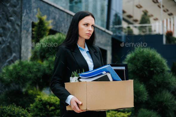Carrying the Burden of Job Loss Unemployed Woman Outside with Box