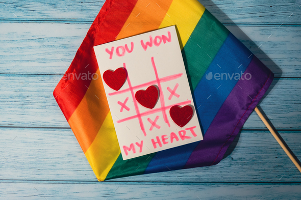 Handmade valentine with Text YOU WON MY HEART and tic tac toe game red envelope and LGBTQ flag. Gift