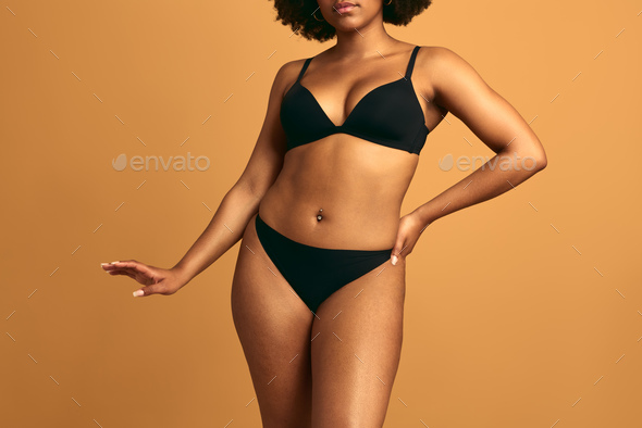 Crop black woman in lingerie with hand on waist