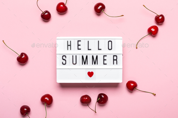 Light box with Hello Summer text and ripe cherries on pink background. Hello Summer concept