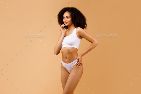 Fitness and diet concept. Tender slim black lady with perfect body