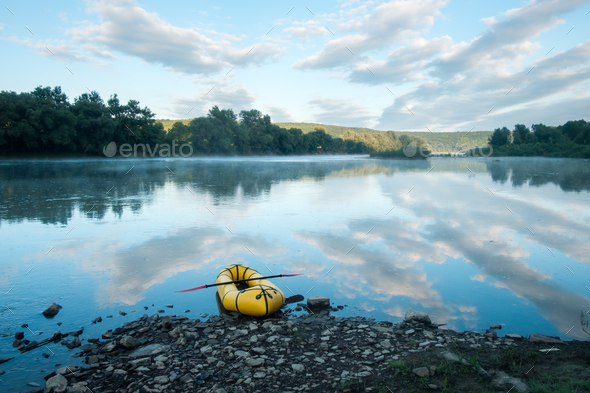 Yellow packraft on beautiful sunrise river - Stock Photo - Images
