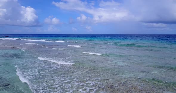 Tropical flying clean view of a white sandy paradise beach and aqua turquoise water background alt
