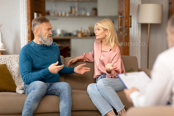 Unhappy Mature Couple Having Quarrel During Marital Therapy Session Indoors