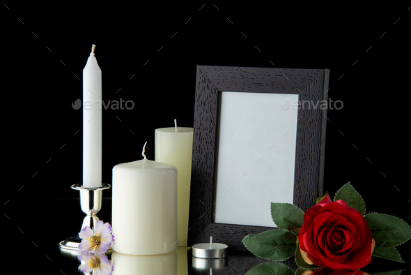 front view of white candles with picture frame on a black background funeral war death palestine