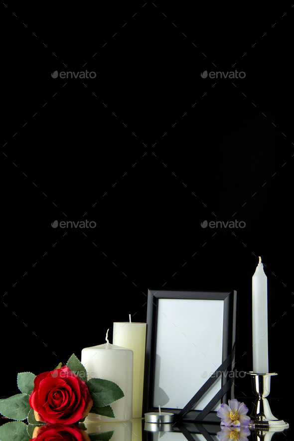 front view of white candles with picture frame on black background palestine funeral war death