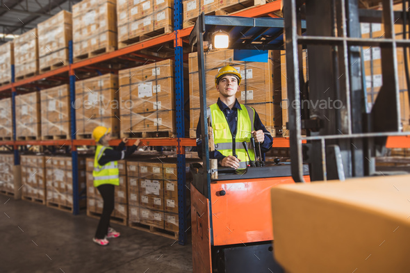 Caucasian male worker working in warehouse goods store. inventory staff moving producs pallet
