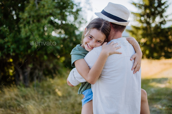 Father hugging his daughter in summer in nature. Father's day concept ...