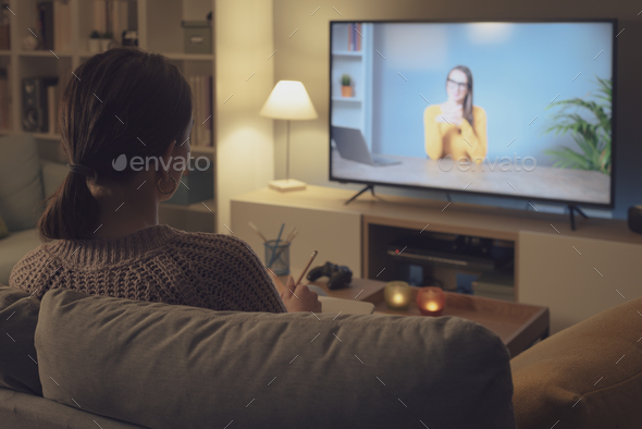 Woman watching an online course on her TV