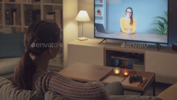 Woman watching an online course on her TV