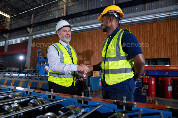 Plant manager visit engineer in factory at production line discuss on quality assurance improvement