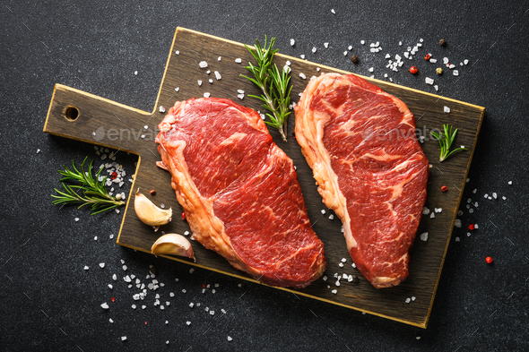 Beef steak. Raw beef meat at black. Stock Photo by Nadianb | PhotoDune