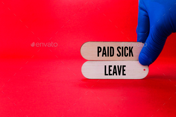 hand holding a stick with the words paid sick leave.