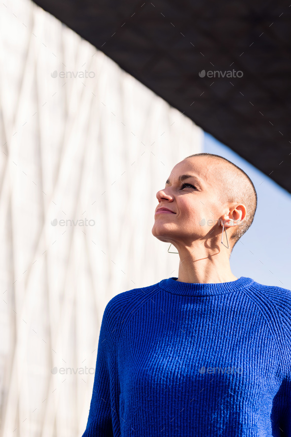 empowered woman with bald head smiling - Stock Photo - Images