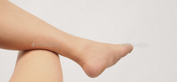 Asian man is bent knee with legs and barefoot on white background