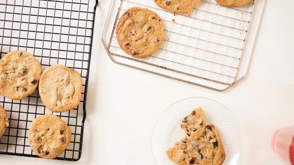 Time lapse. Little girl eating home made chocolate chip cookies wile baking them with her mother. alt