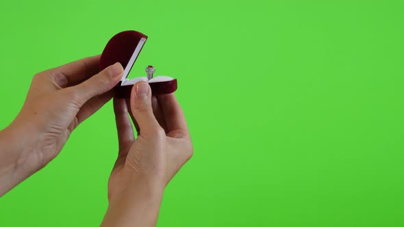 Silver ring in red box presenting in front of green screen 4K 2160p UltraHD footage - Green screen d alt