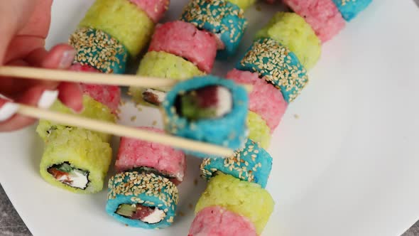 Traditional Japanese Sushi Rolls Made From Colorful Rice and Stuffed with Salted Fish and Vegetables alt