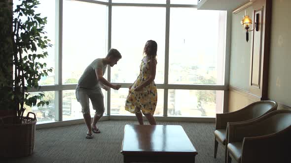 Dancing Couple Against Large Window