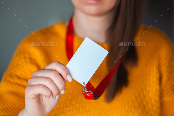 Woman holding badge name tag, with blank space mock up