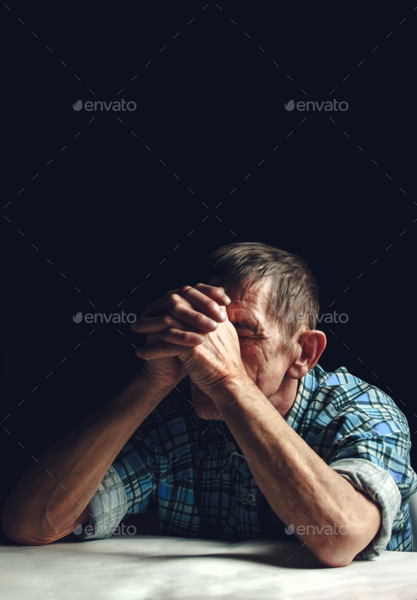 Depressed senior covers his face with his hands. Alzheimer\'s disease concept.