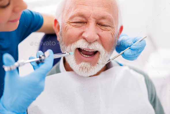 Dentist applying local anesthetic