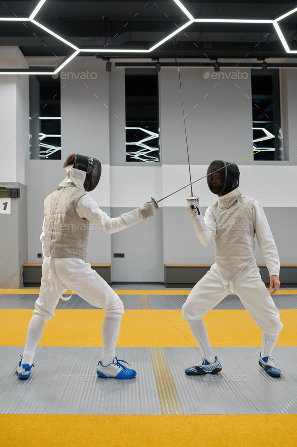 Fencing partners fighting with rapiers practicing attack and defense ...