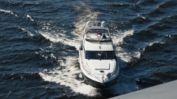 white yacht sails on the water on the waves
