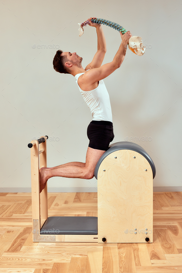 Young Girl doing exercises on ladder barrel - Pilates Stock Photo