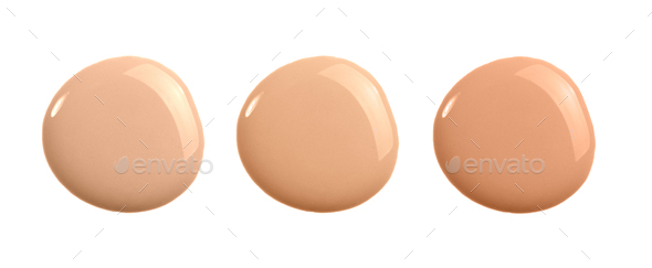 Set of shades of liquid concealer isolated on white. Beige nude liquid foundation smear smudge drop.