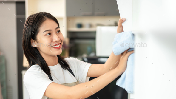 Half Japanese Housewife Is Cleaning The Showcase And Shelving In The