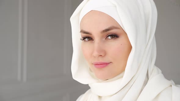 Portrait of Muslim Arabian Woman Wearing Hijab Looking at Camera and Smiling alt