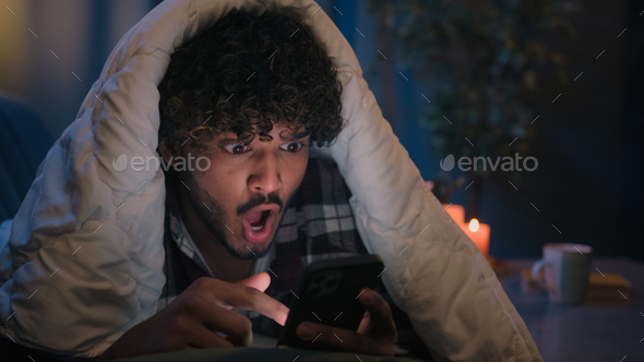 Shocked guy Indian man Arabian male shock wonder reading news in phone social media amazed with - Stock Photo - Images