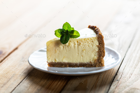 Slice of New York cheesecake with a sprig of mint - Stock Photo - Images