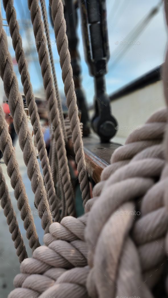 Vertical closeup of ropes and rigging on an old sail ship holding