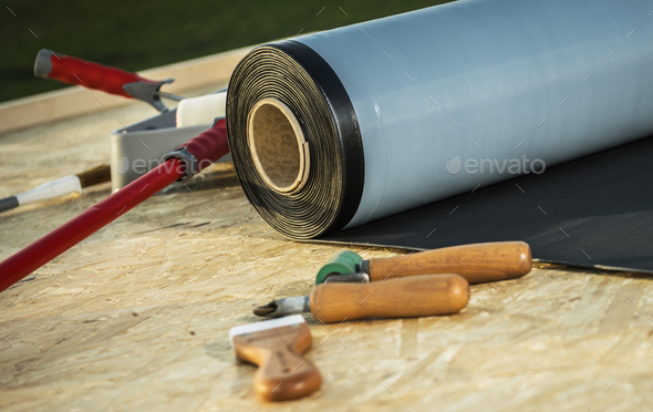 Roll of EPDM Roofing Rubber Material and Some Tools - Stock Photo - Images
