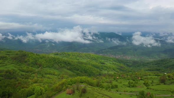 Epic aerial flight over green forest in the sunset. alt
