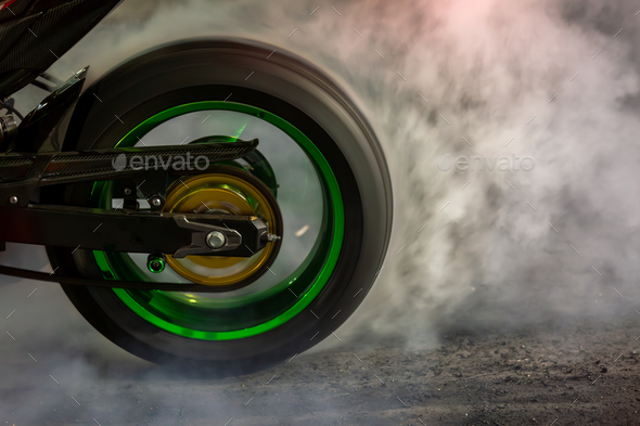 Motorbike burning tire rubber on road, Motorbike wheel drifting and white smoking on track