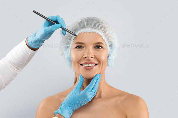 Happy middle aged woman wearing medical hat with perforation lines
