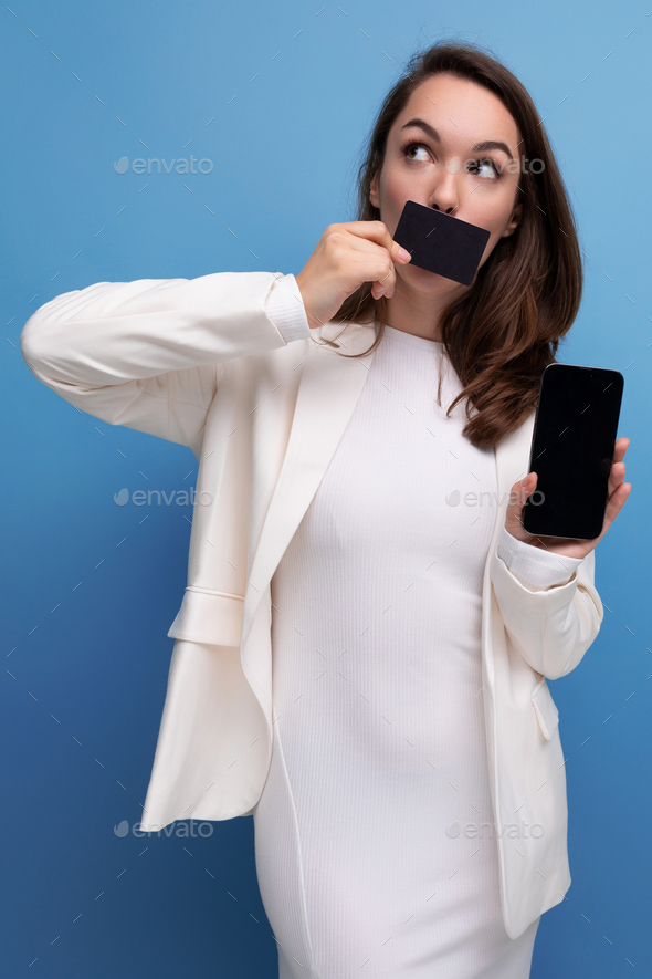 financial worker brunette young woman in a dress and jacket with a payment card for shopping and a