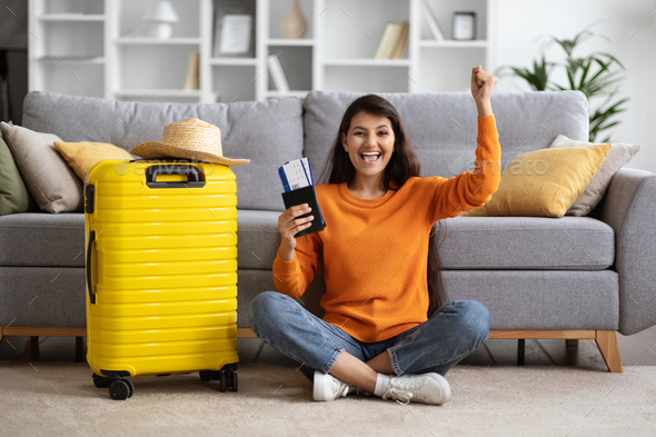 Young woman packing luggage in bedroom at home stock photo