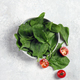 fresh spinach in a gray plate on a light gray background top view - PhotoDune Item for Sale